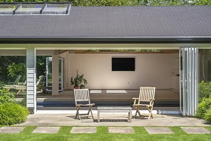 External view of an indoor pool house with a heated pool