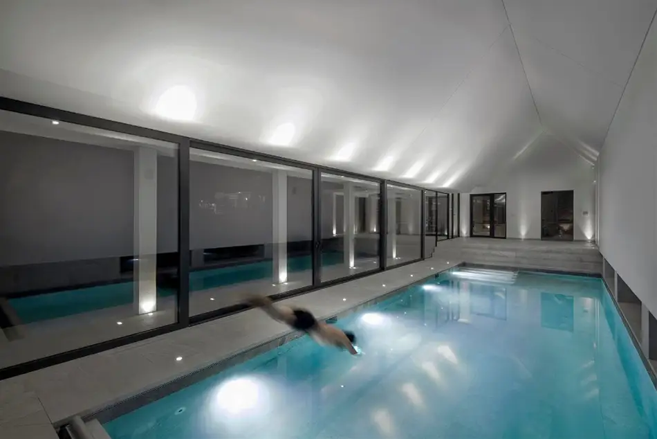 Man diving into an indoor swimming pool